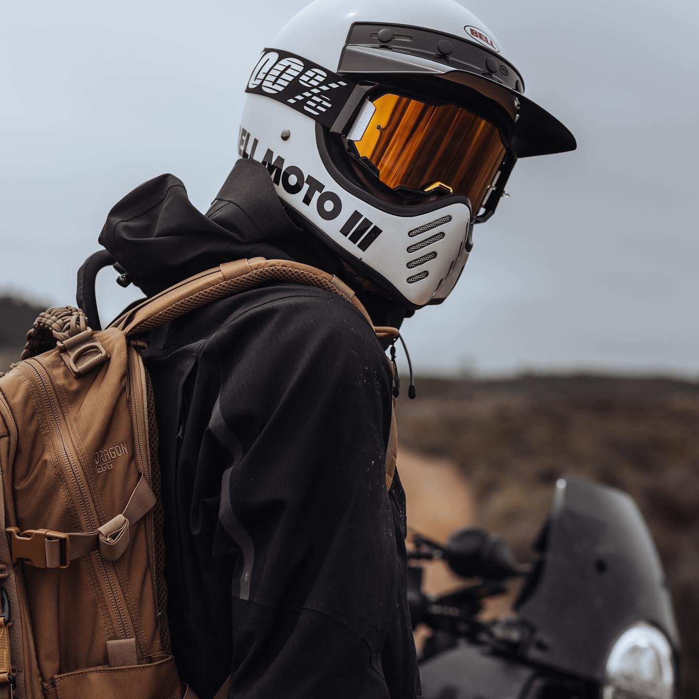 Adventure rider with his motorcycle at the back.